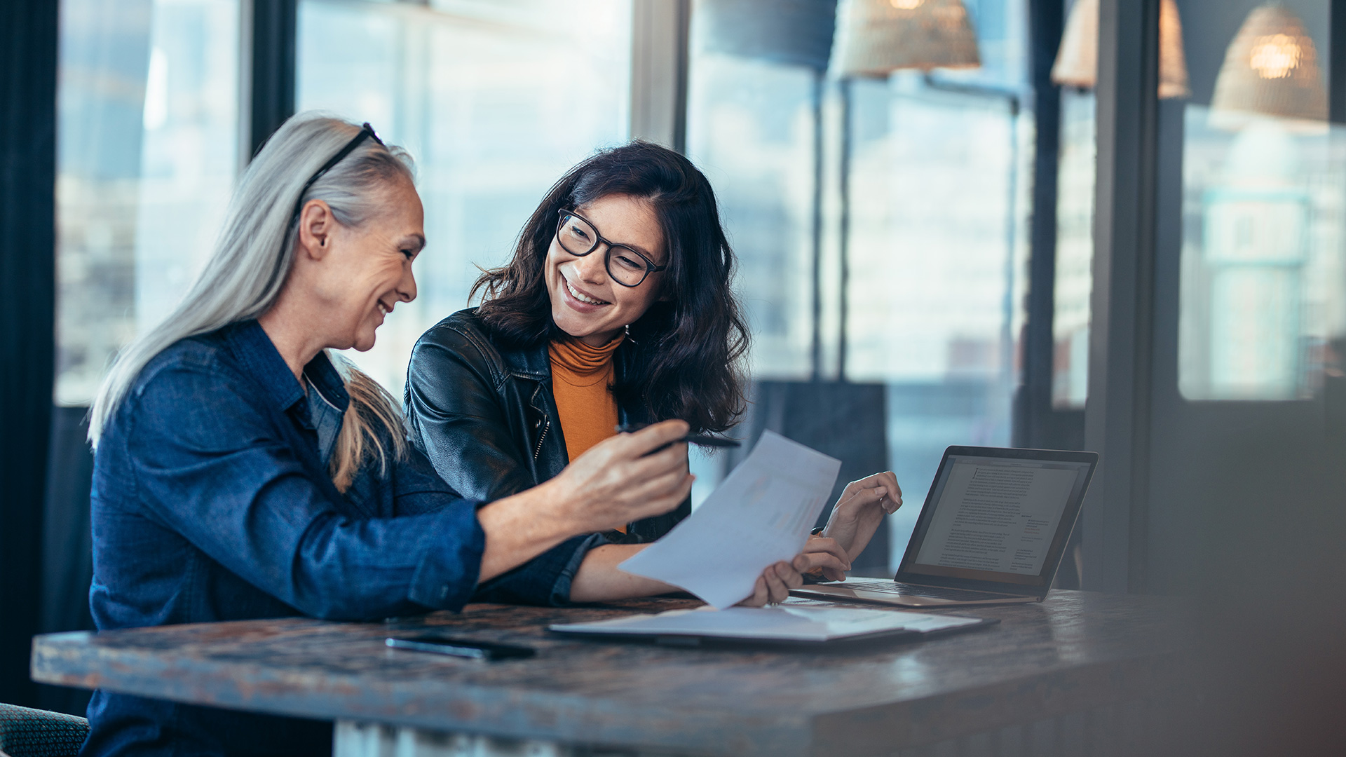 Two women executives discussing year end marketing budget allocations