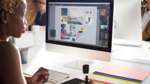 Black woman designer working on a computer