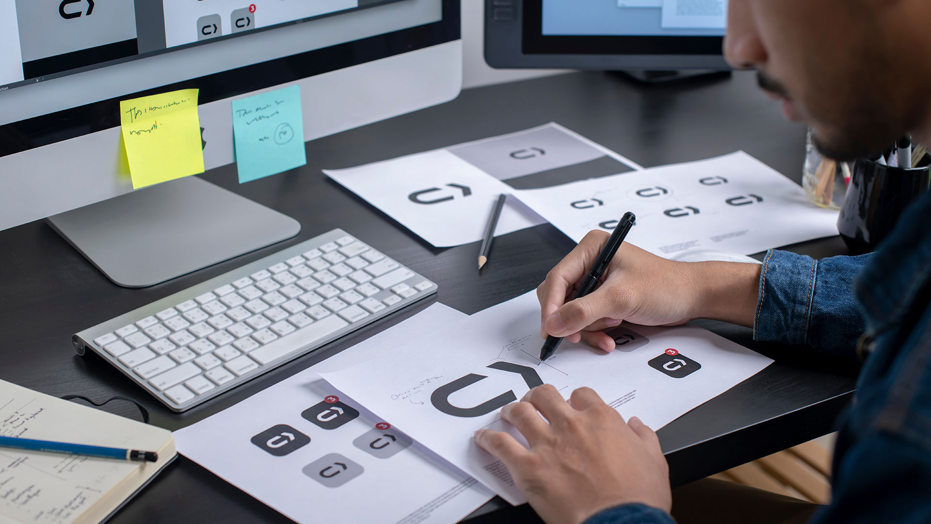 Logo Designer creating a logo system